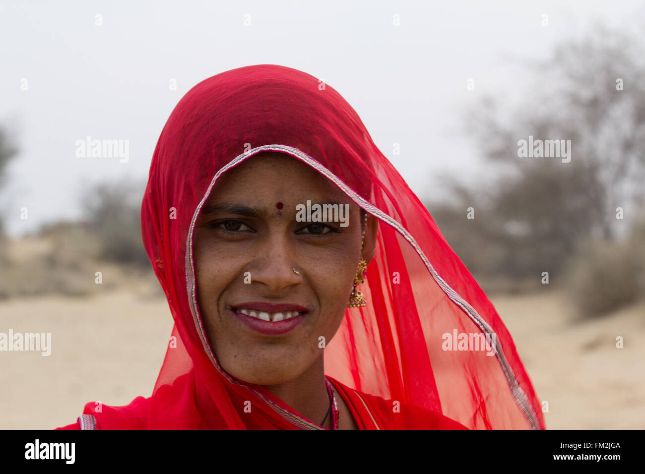 Asia, India,Rajasthan, Manvar,desert, sand dunes. Woman in traditional headscarf. Stock Photo
