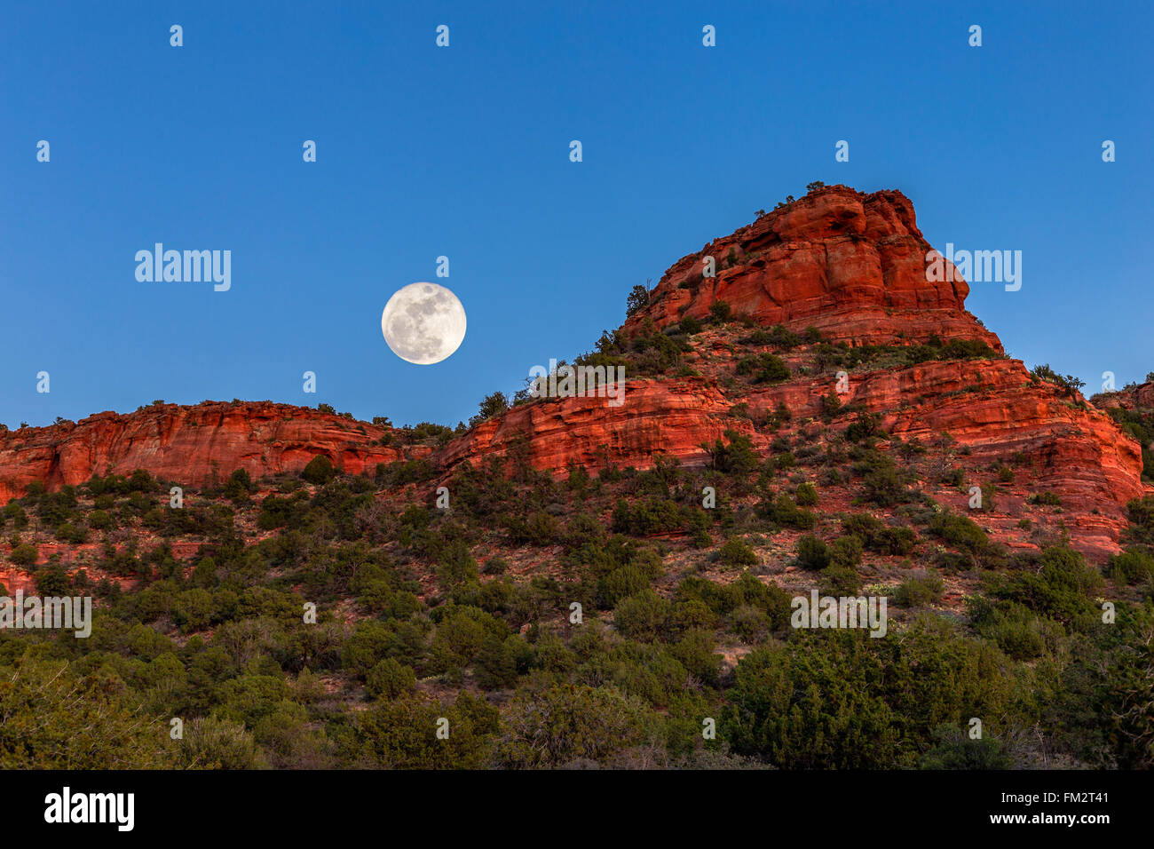 Moon over the Sedona red rocks in Arizona Stock Photo