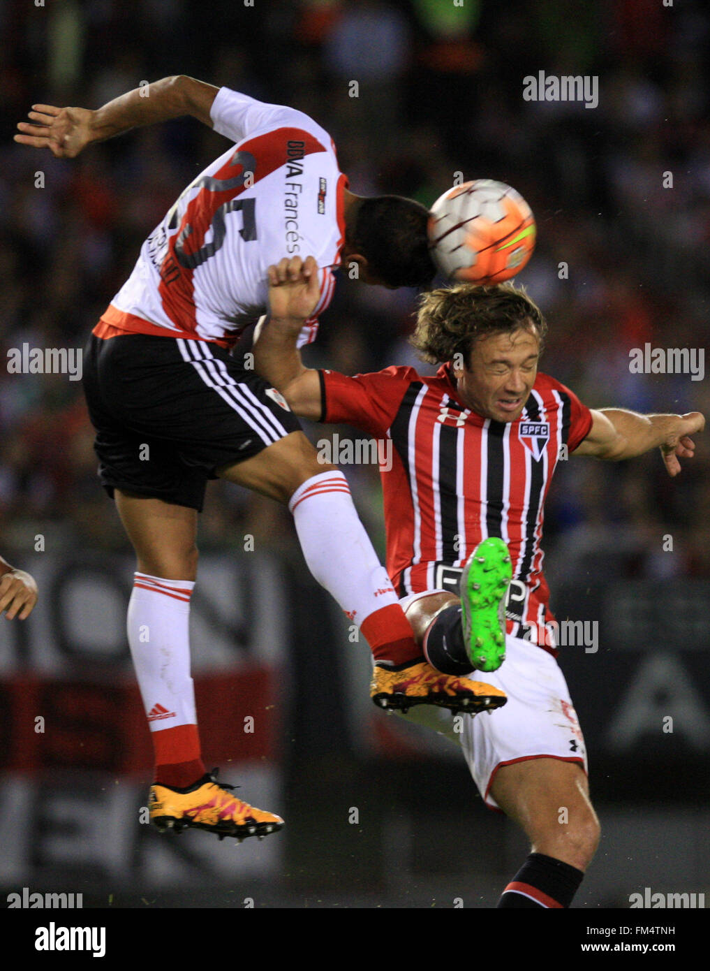 Buenos Aires, Argentina. 10th Mar, 2016. Gabriel Mercado (L) of Argentina's River Plate, vies with Diego Lugano of Brazil's Sao Paulo, during the Group 1 match of the Libertadores Cup, held at Antonio Vespucio Liberti Stadium, in Buenos Aires city, capital of Argentina, on March 10, 2016. © Martin Zabala/Xinhua/Alamy Live News Stock Photo