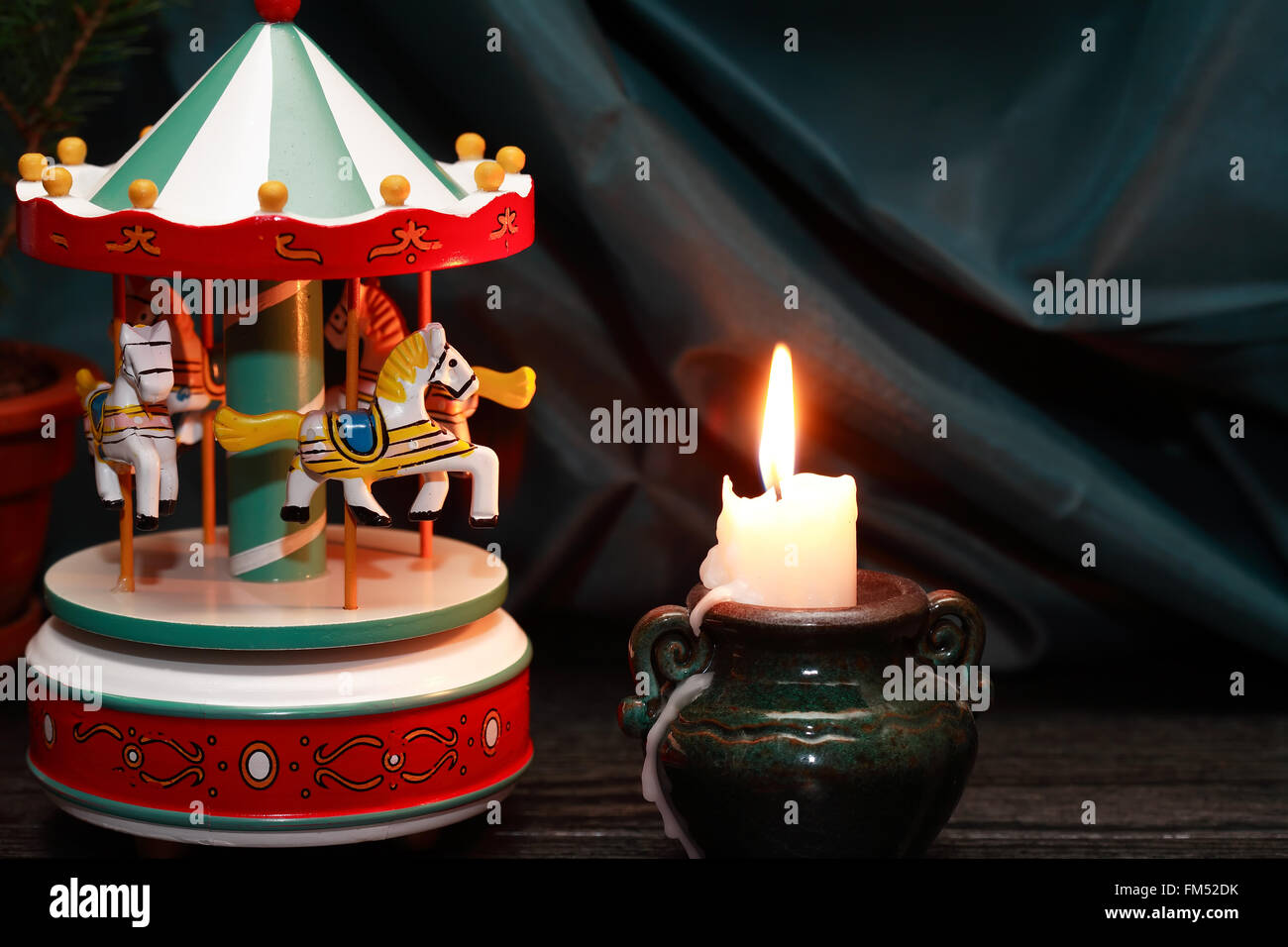 Vintage wooden toy carousel horses near lighting candle Stock Photo Alamy