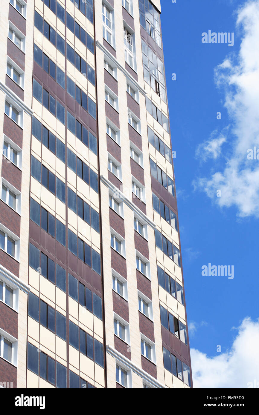New modern building against blue sky with white clouds Stock Photo - Alamy