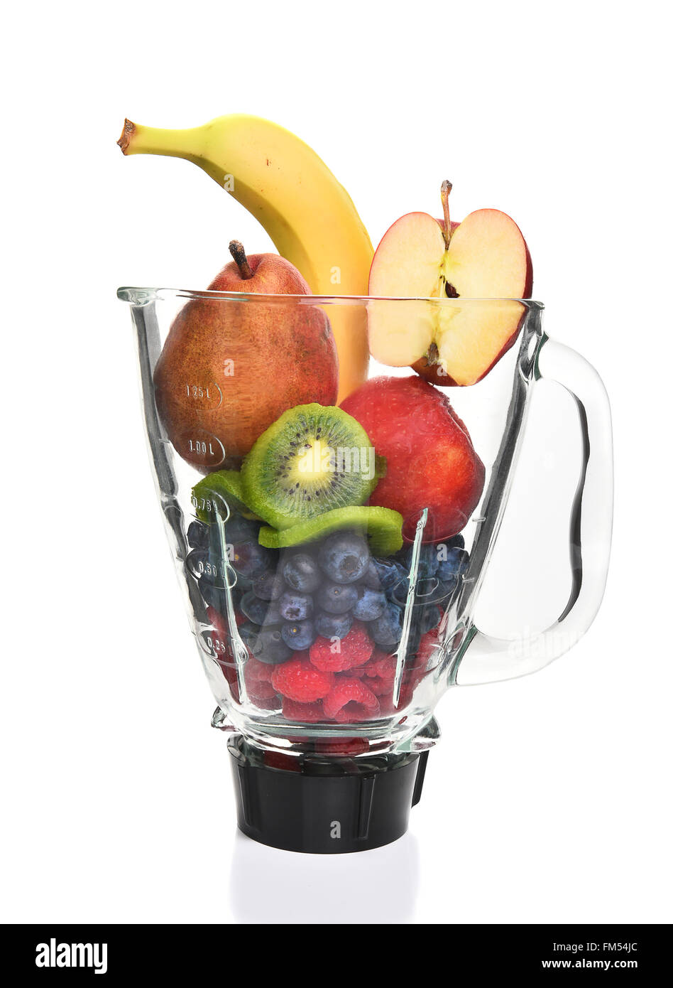 A blender filled with fresh whole fruits for making a smoothie or juice. Healthy eating concept. Stock Photo