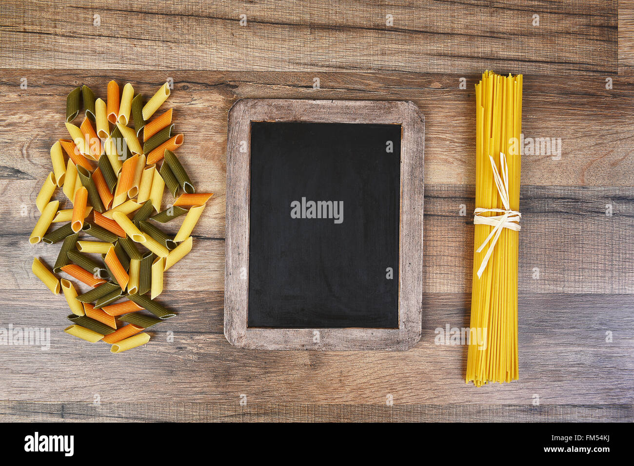 Top view of colorful rigatoni pasta and spaghetti with a blank ...