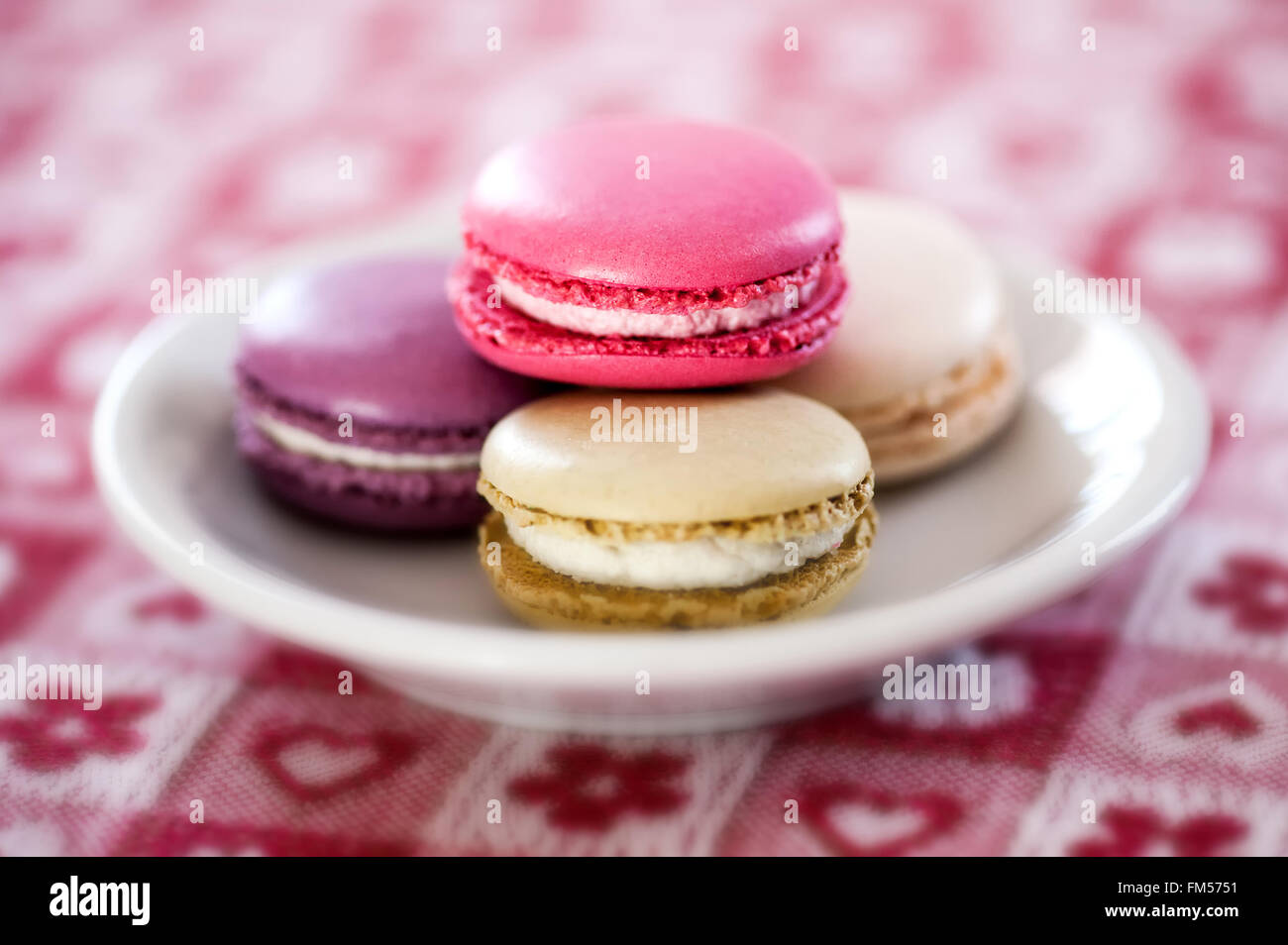 Plate of colorful macaroons made with egg-white, almonds and filled with butter cream Stock Photo