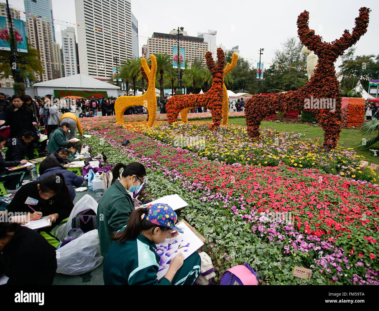 Hong Kong, China. 11th Mar, 2016. Visitors draw pictures of flowers during the Hong Kong Flower Exhibition at the Victoria Park in Hong Kong, south China, March 11, 2016. © Ng Wing Kin/Xinhua/Alamy Live News Stock Photo