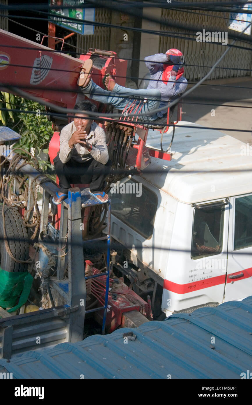 Two men are operating a cherry picker while working on power and