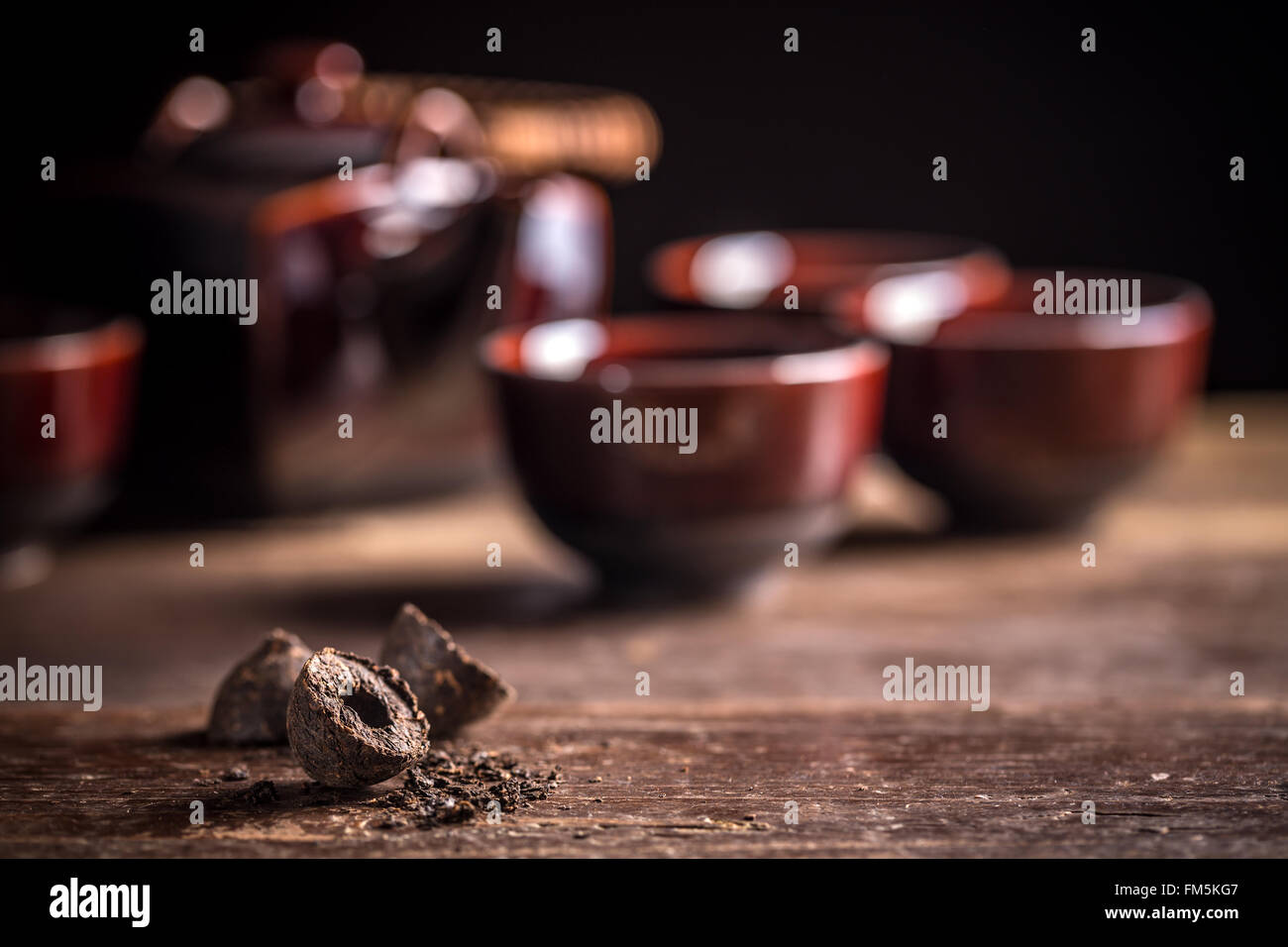 Compressed pu-erh chinese tea on rustic wooden background Stock Photo