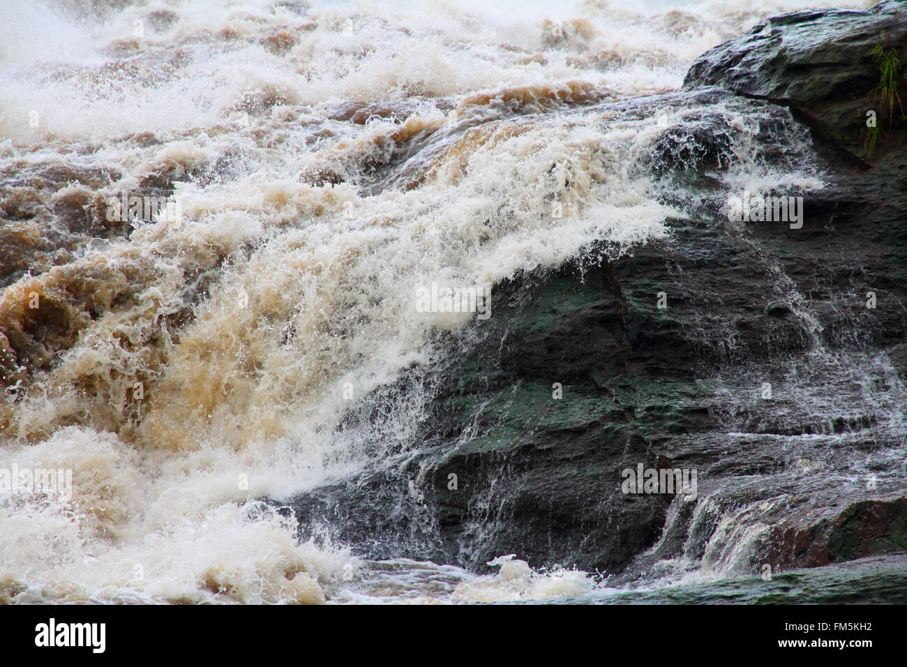 Water flowing over a rock outcropping at the top of Murchison Falls in Uganda. Stock Photo