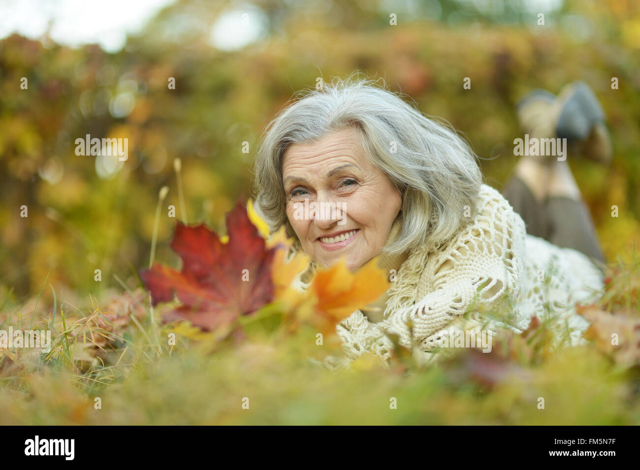 Elderly woman lying Stock Photo - Alamy