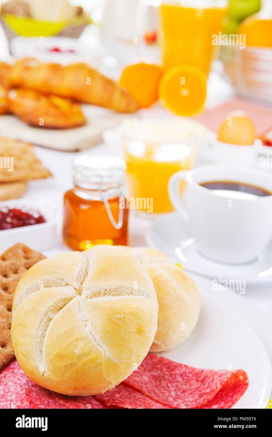 A large buffet-style continental breakfast on a brightly lit table. Stock Photo