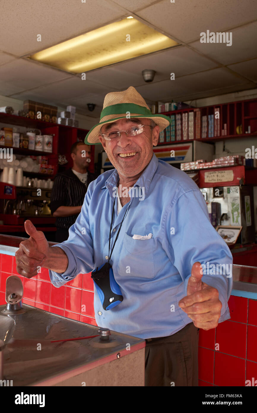 Elderly man with straw hat makes both thumbs up Stock Photo
