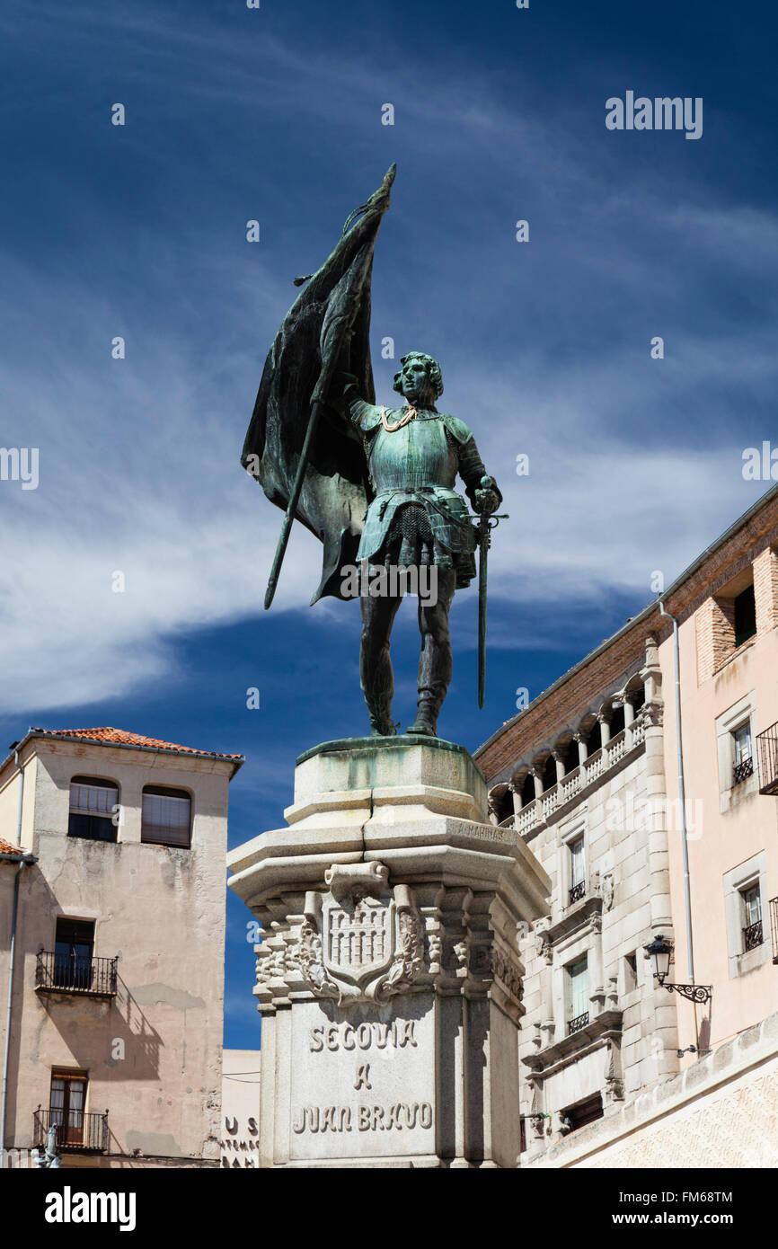 A view from below the bronze statue of Juan Bravo, stood on a plinth with sword and flag in Segovia in Spain. Stock Photo