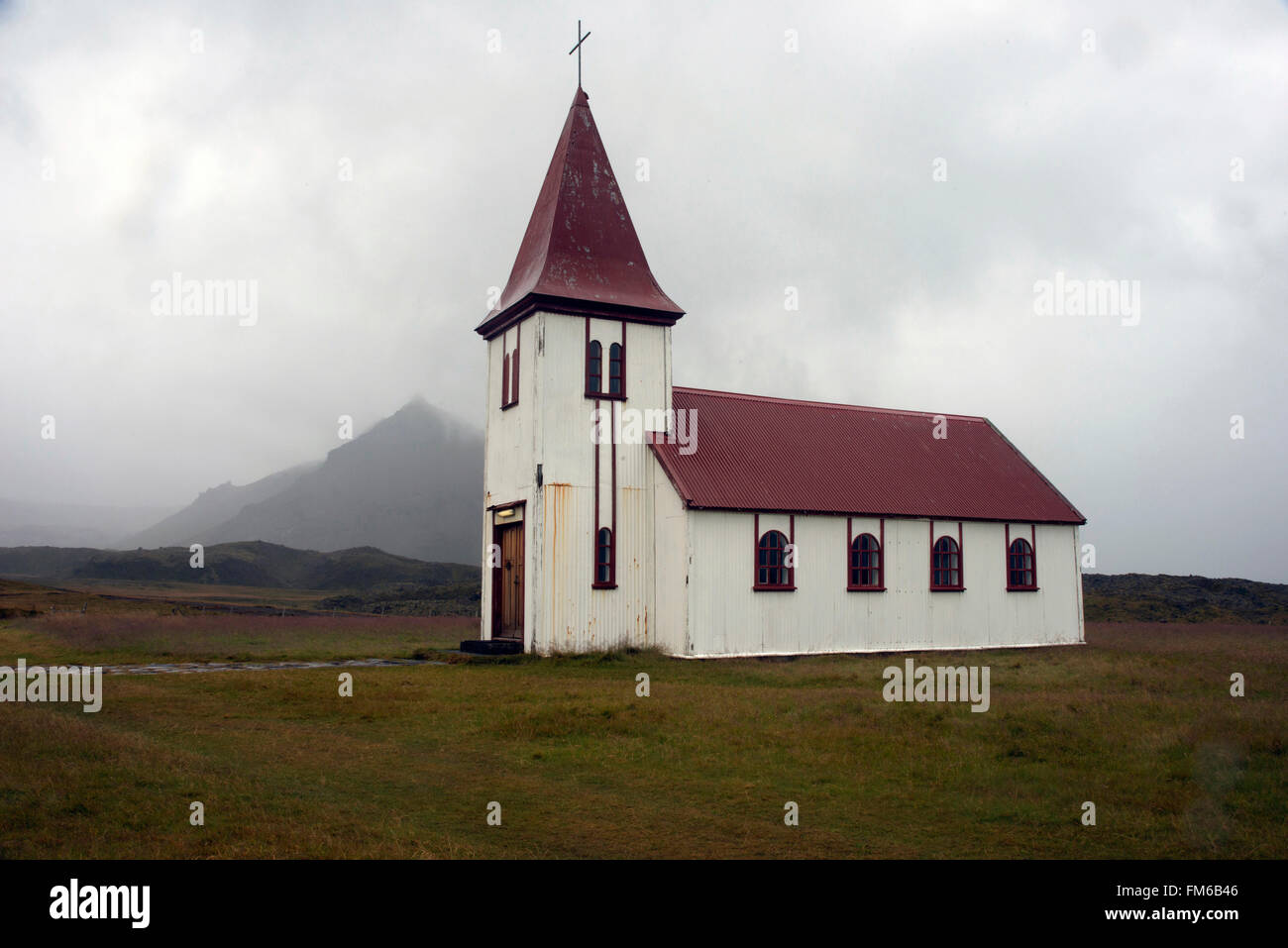 A exterior view of a church in the middle of a field, in Hellnar. Stock Photo