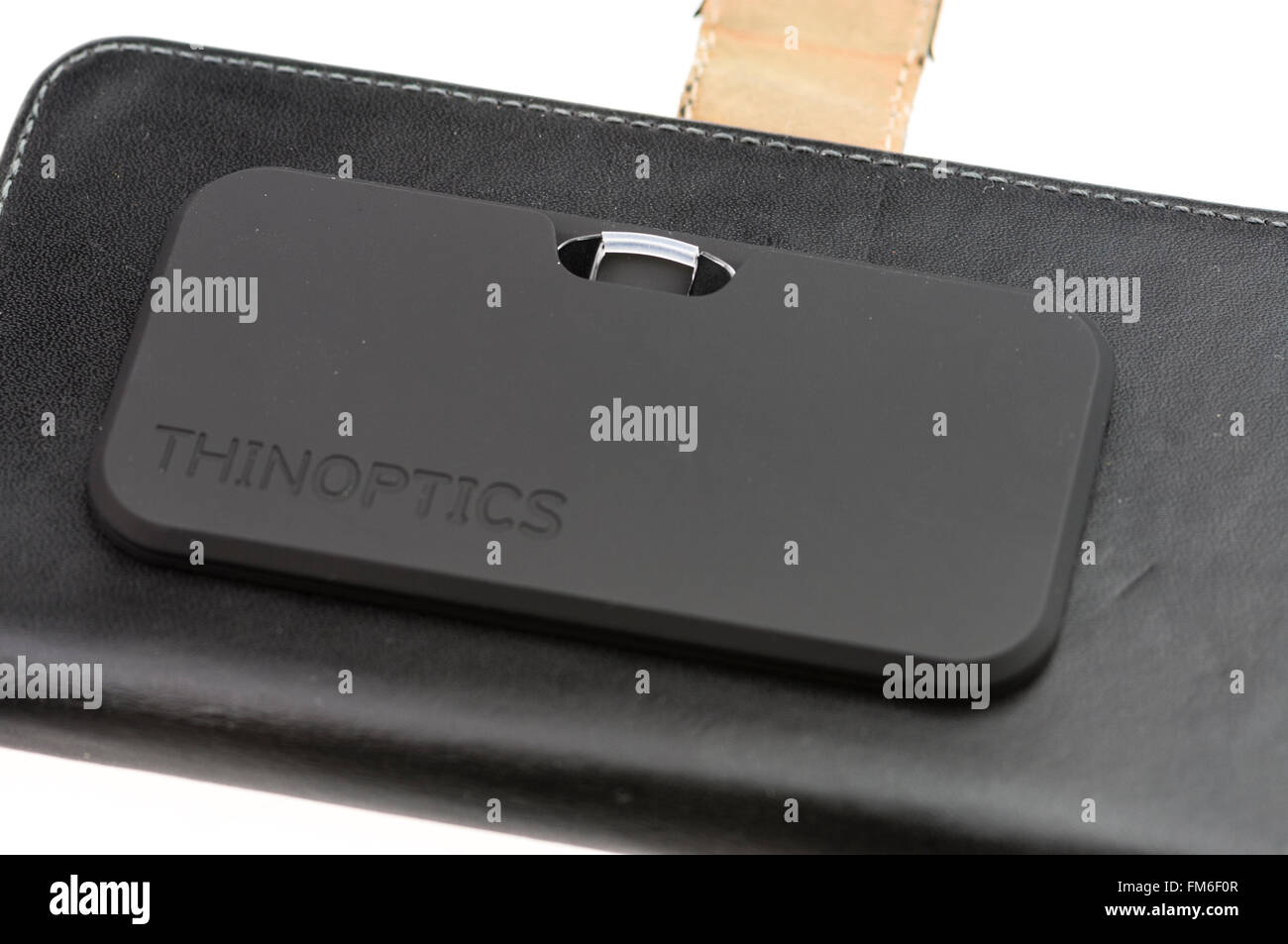 ThinOptics reading glasses in a case stuck to a mobile phone case Stock