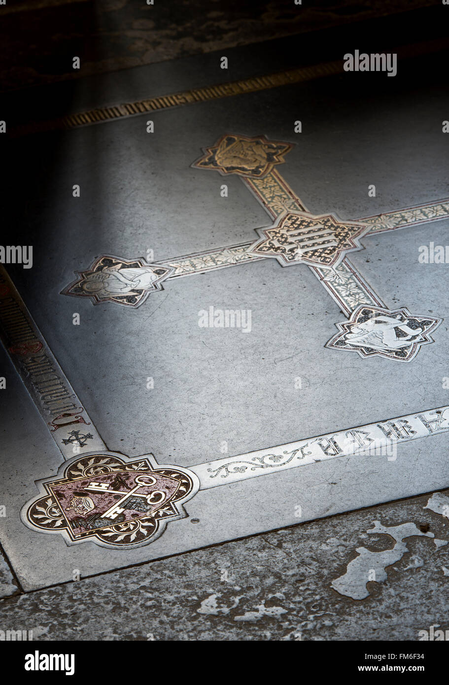 Black purbeck ledger with crossed keys and victorian brass inlaid cross on the floor of the retrochoir in Wells Cathedral. UK Stock Photo