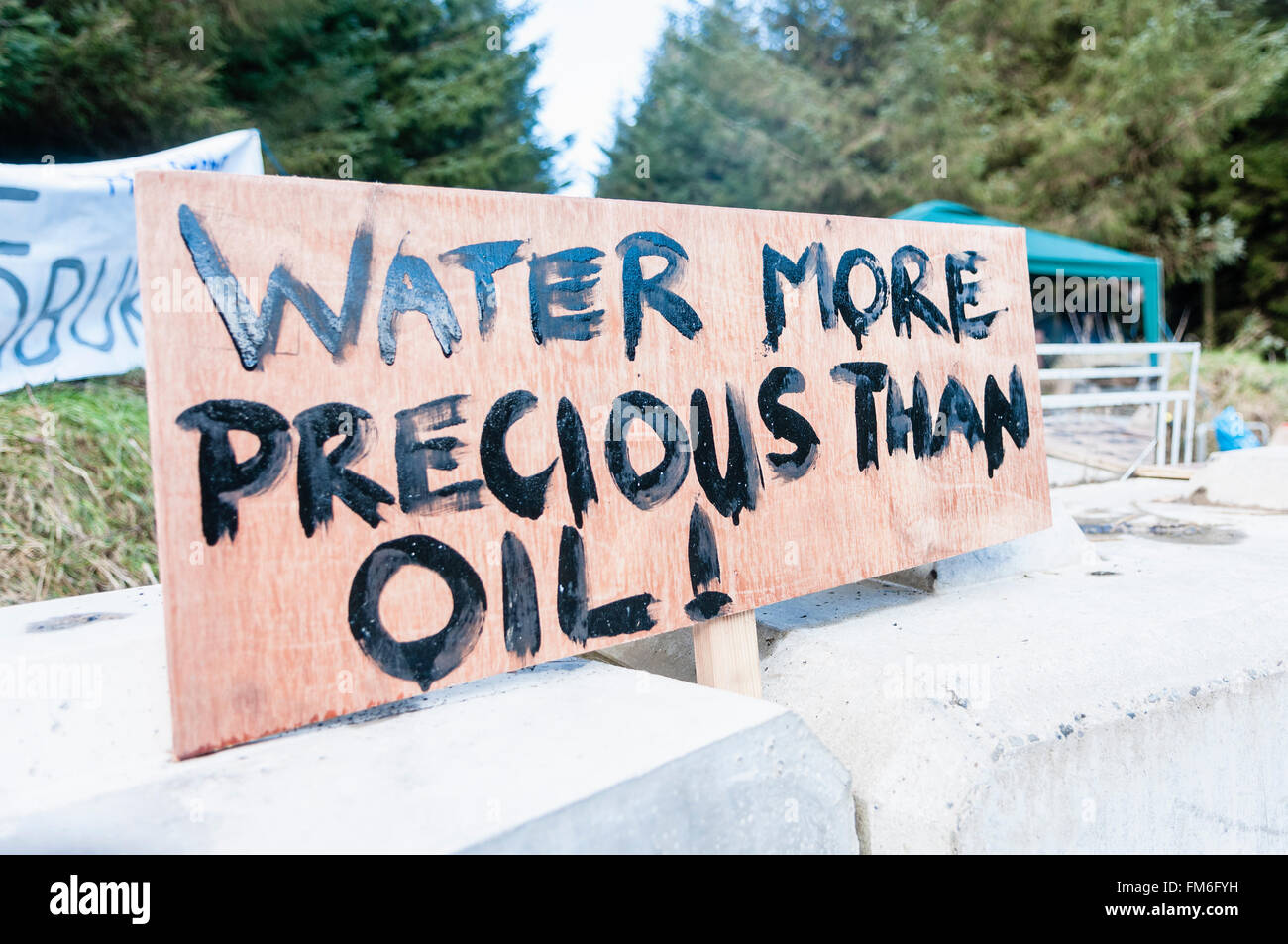 Sign at a oil drilling protest saying 'water more precious than oil!' Stock Photo