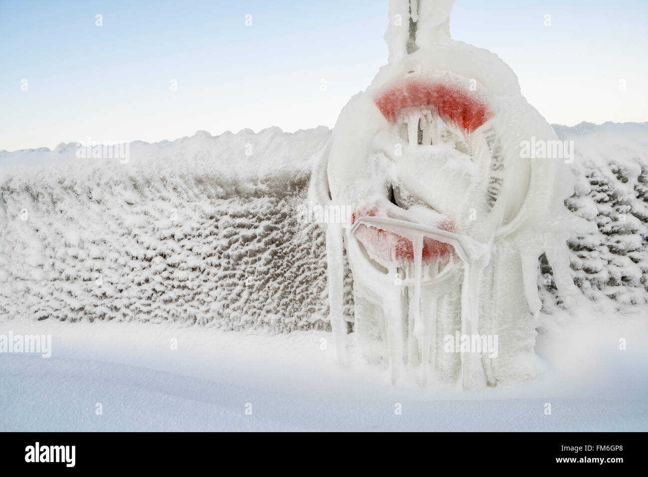 Frozen life buoy with icicles at a port i the winter by a frozen sea. Roslagen, Uppland, Sweden, Scandinavia Stock Photo