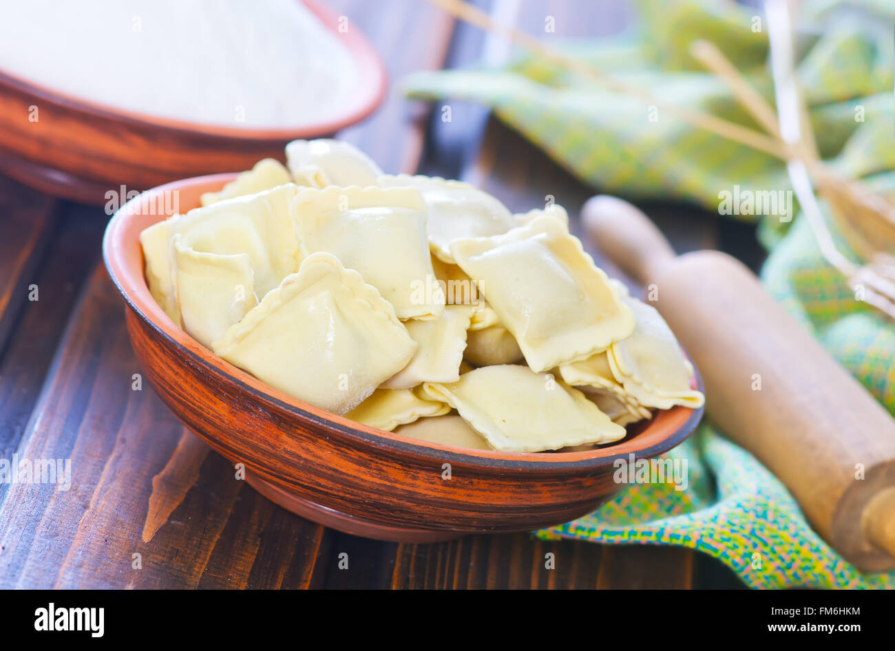 raw ravioli and flour on a table Stock Photo - Alamy