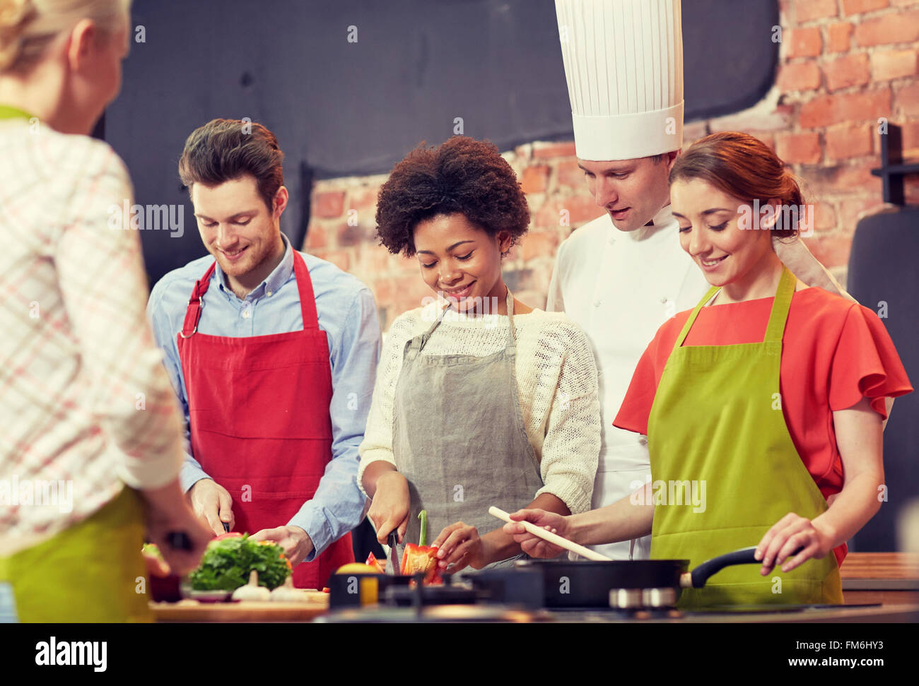 happy friends and chef cook cooking in kitchen Stock Photo - Alamy