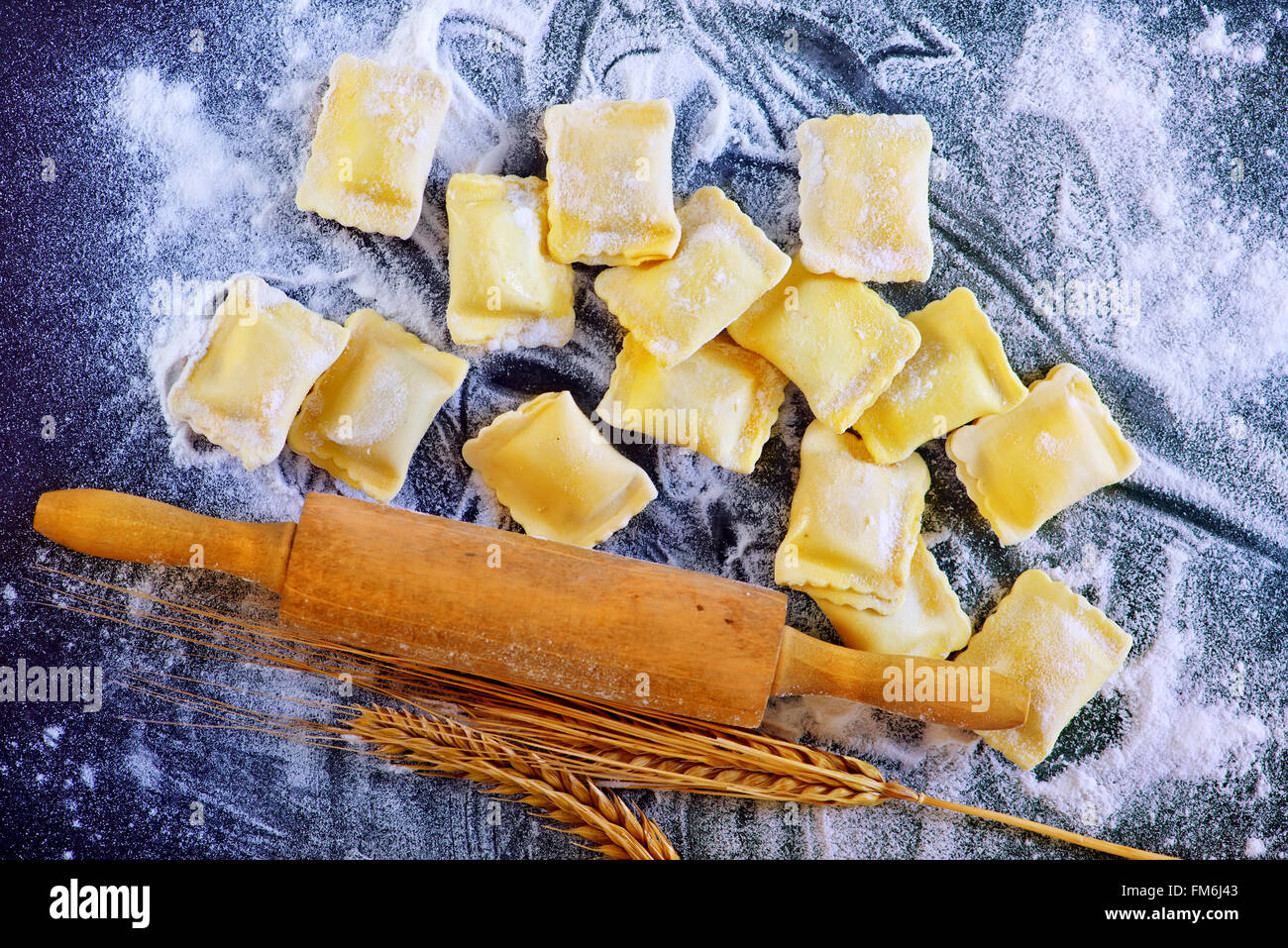 raw ravioli and flour on a table Stock Photo - Alamy