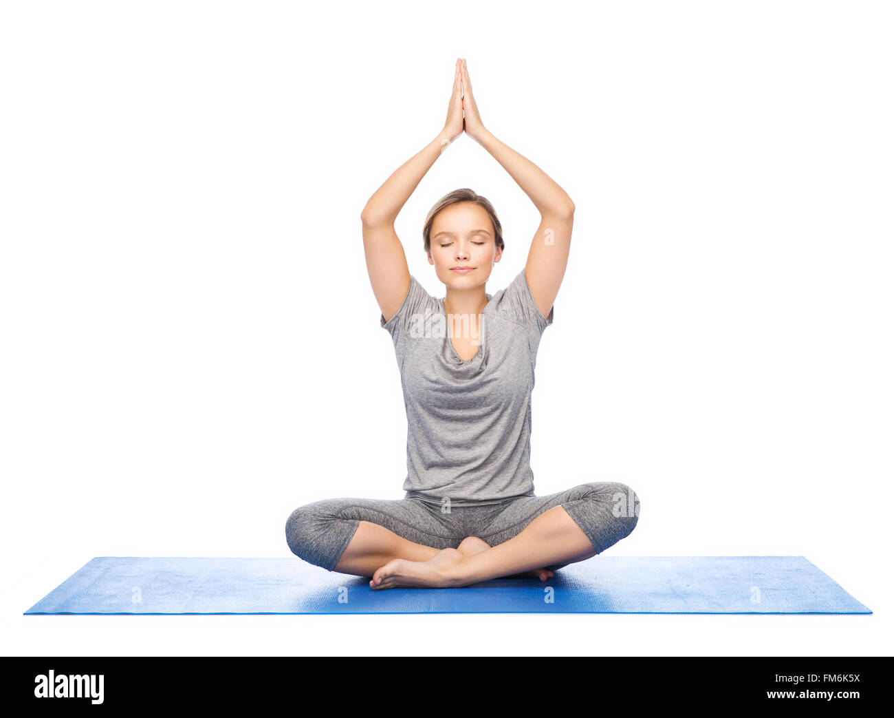 woman making yoga meditation in lotus pose on mat Stock Photo - Alamy