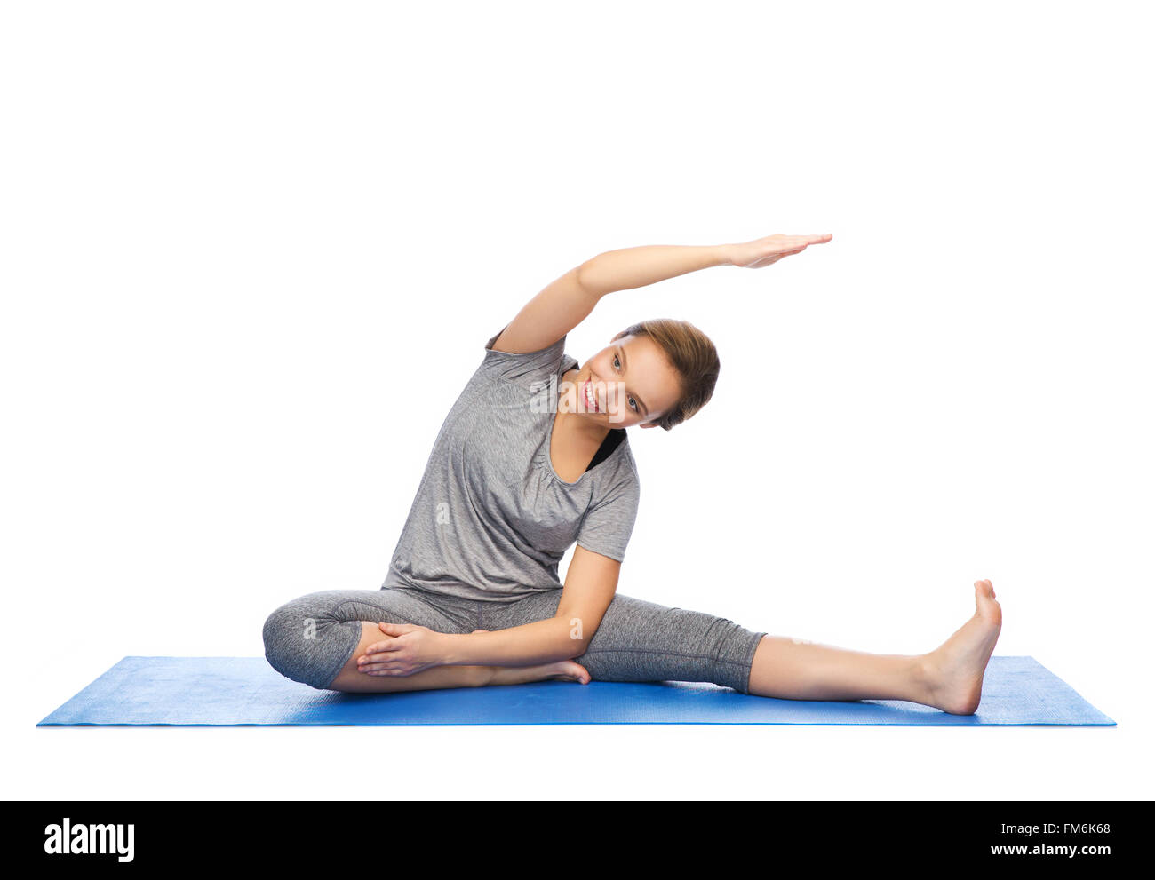 happy woman making yoga and stretching on mat Stock Photo - Alamy