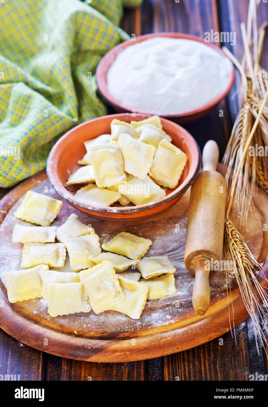 raw ravioli and flour on a table Stock Photo - Alamy