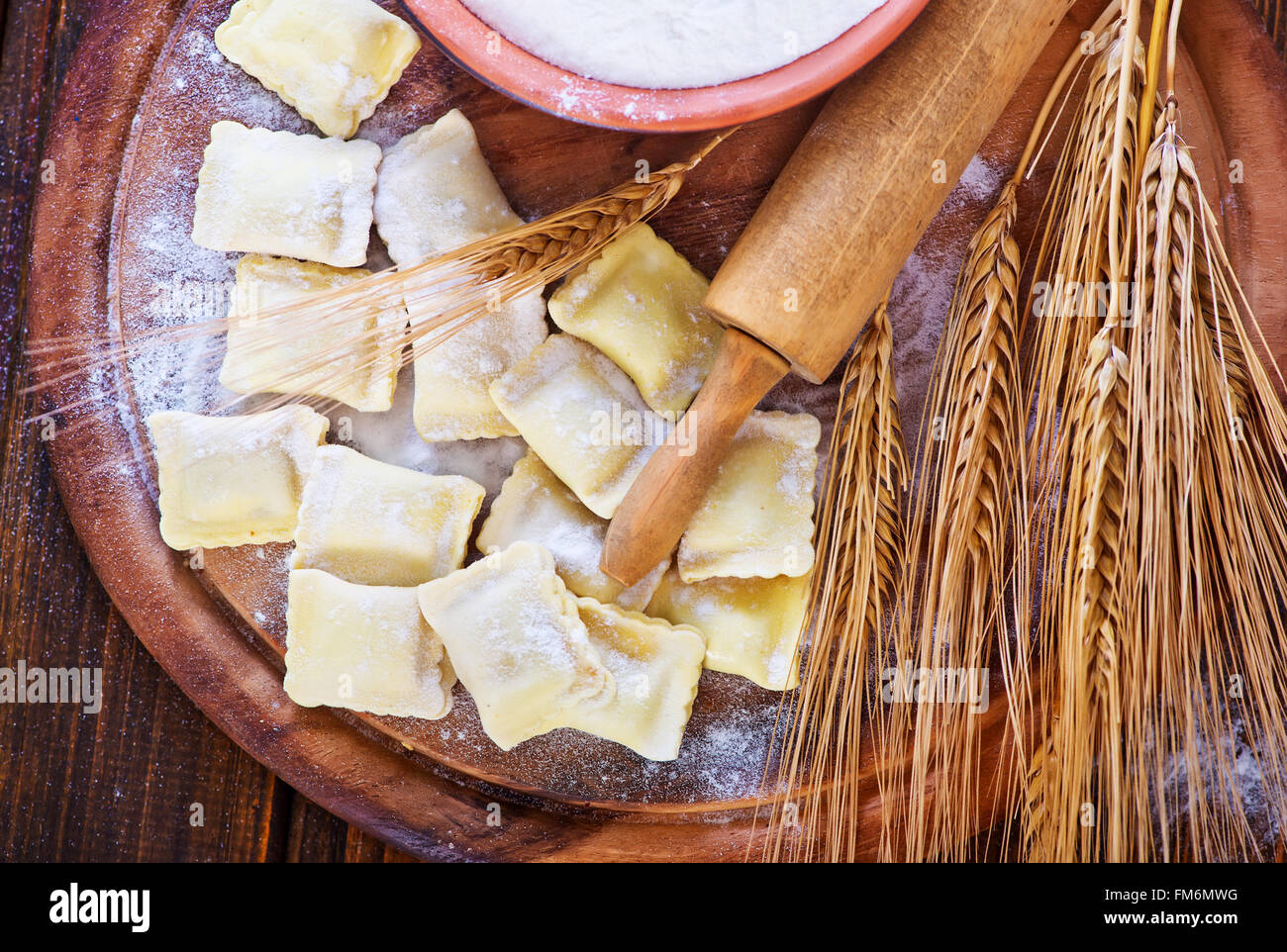 raw ravioli and flour on a table Stock Photo - Alamy