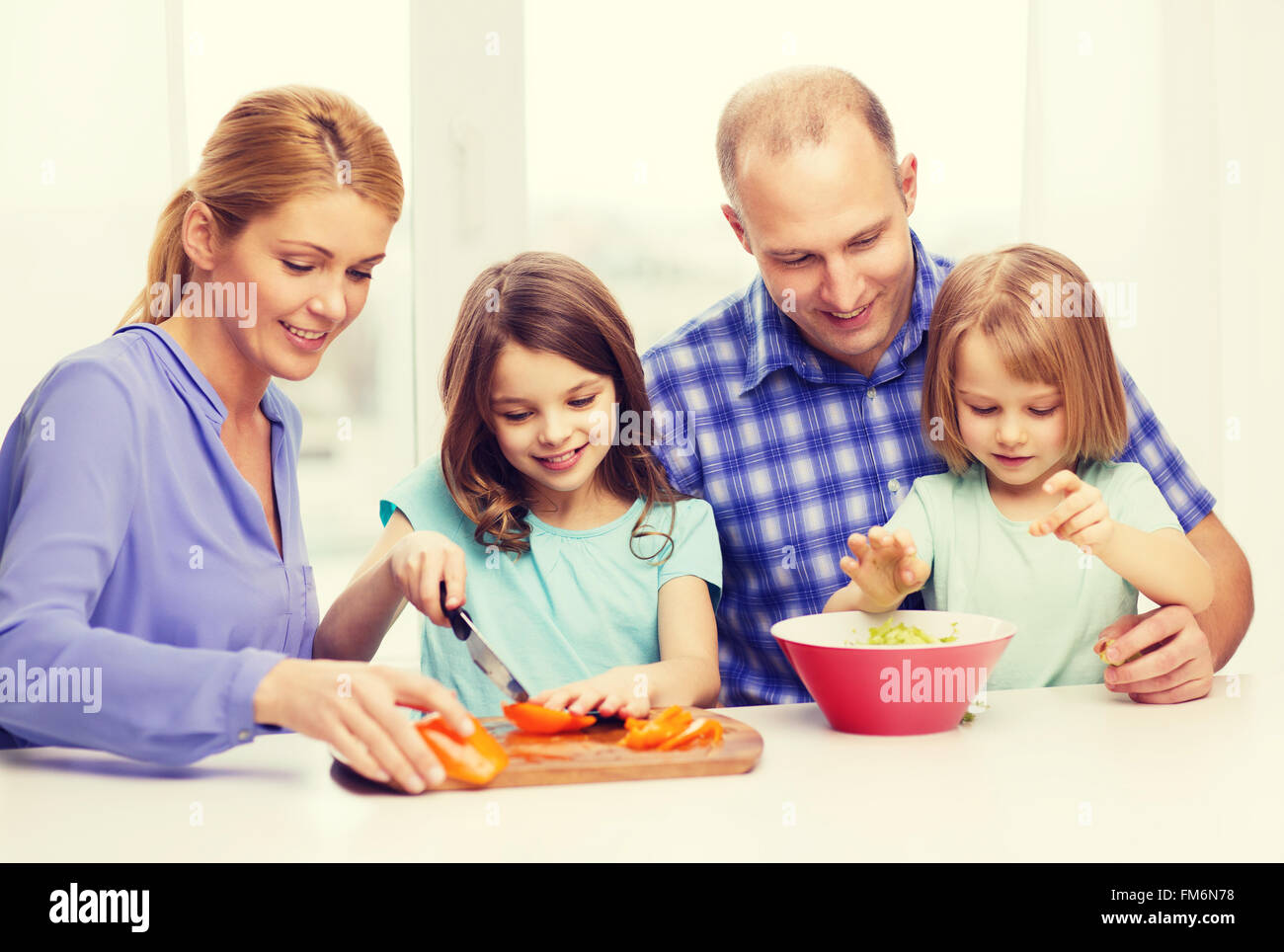 happy family with two kids making dinner at home Stock Photo - Alamy