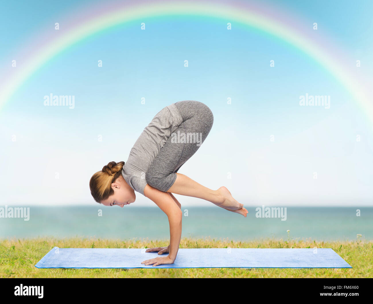 woman making yoga in crane pose on mat Stock Photo Alamy