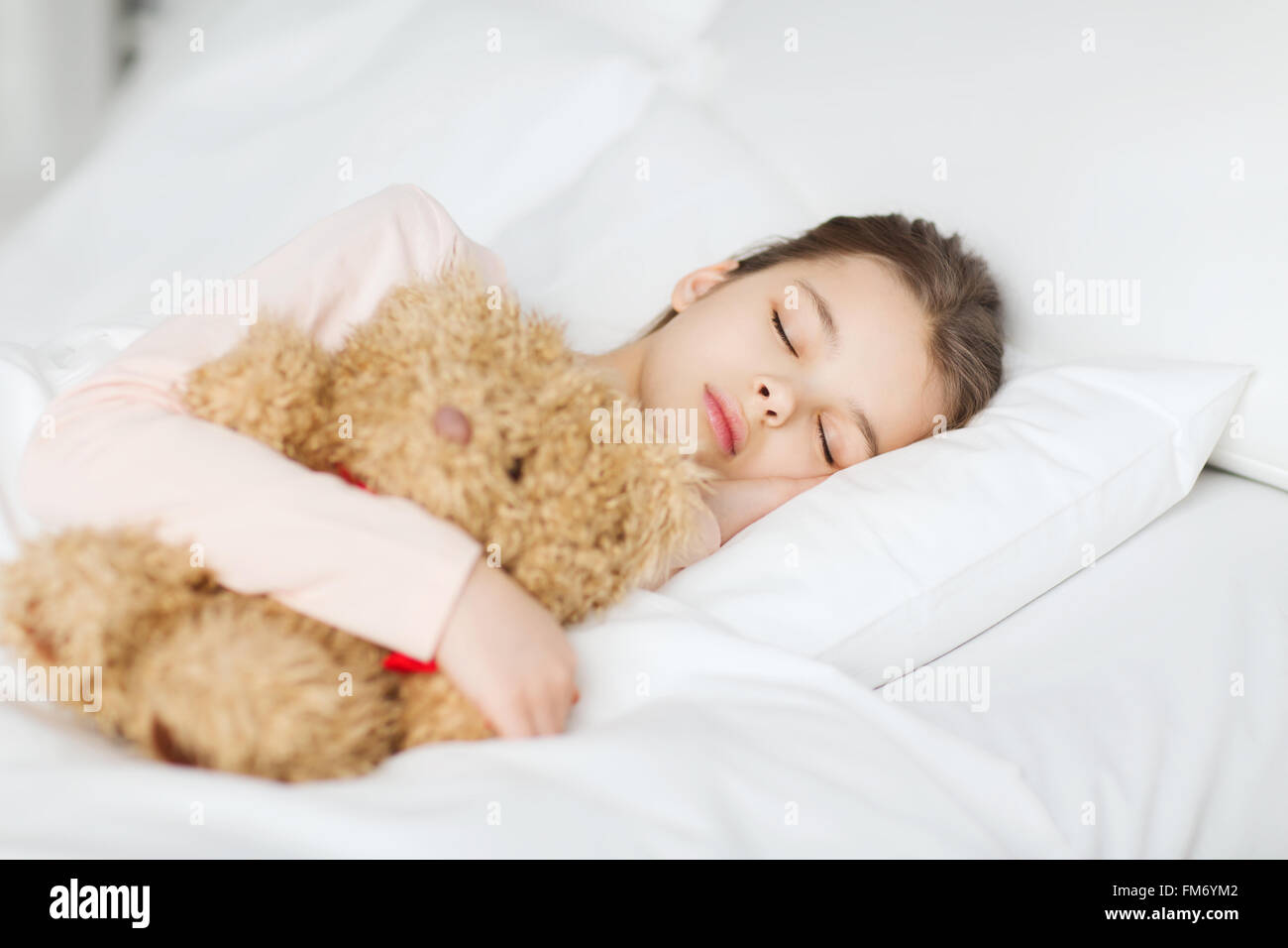 girl sleeping with teddy bear toy in bed at home Stock Photo - Alamy
