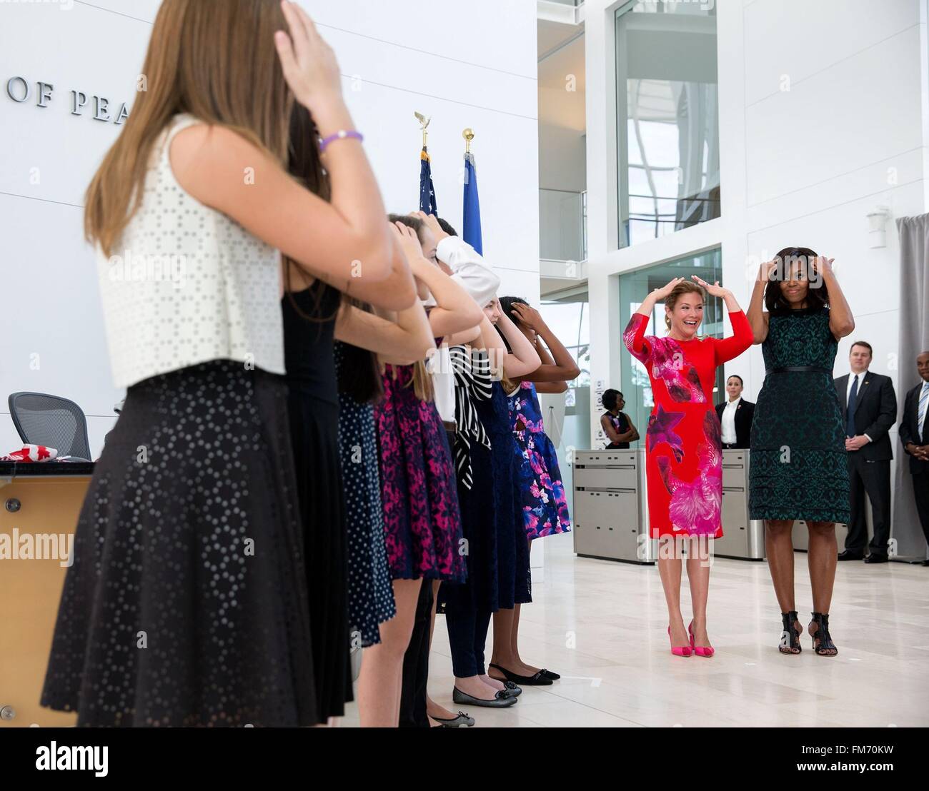 U.S. First Lady Michelle Obama and Canadian First Lady Sophie Gregoire Trudeau listen to students sing during a program at the United States Institute of Peace March 10, 2016 in Washington, DC. This is the first state visit by a Canadian Prime Minister in 20-years. Stock Photo