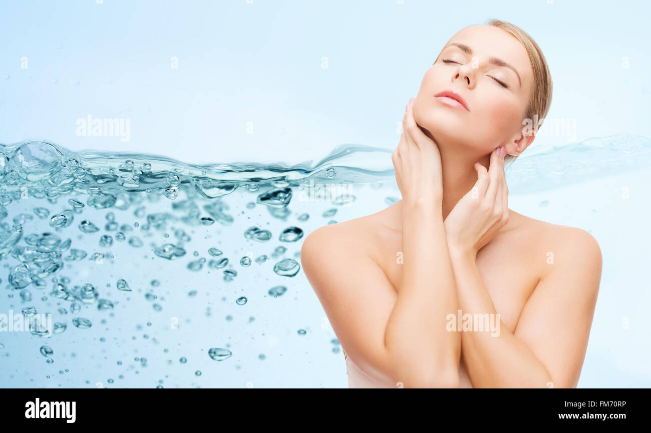 young woman touching her neck Stock Photo - Alamy
