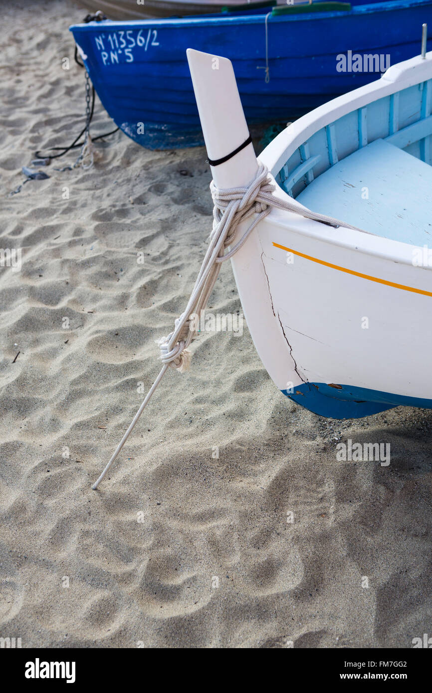 Small traditional fishing boat floating in the sea at coast with