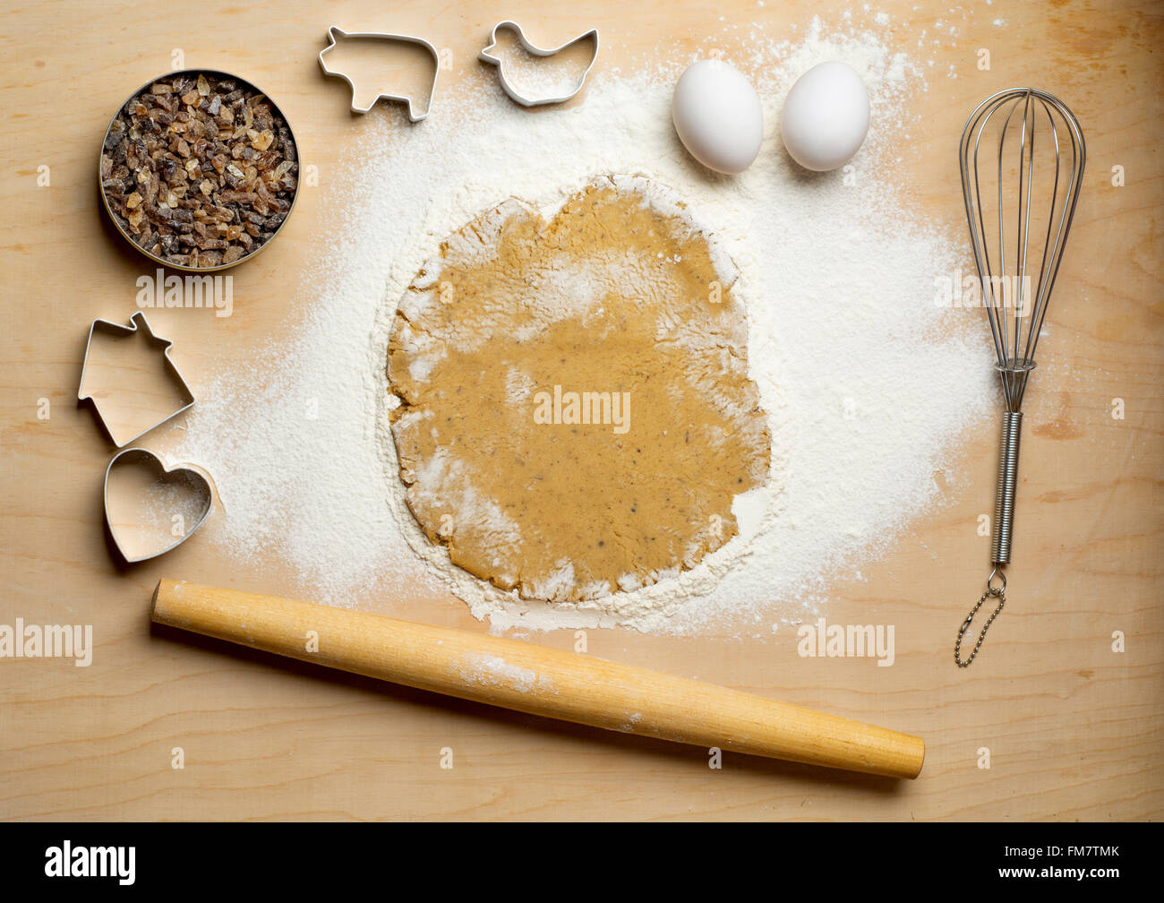 Dough with rolling pin on the wooden table. Kitchen background Stock Photo