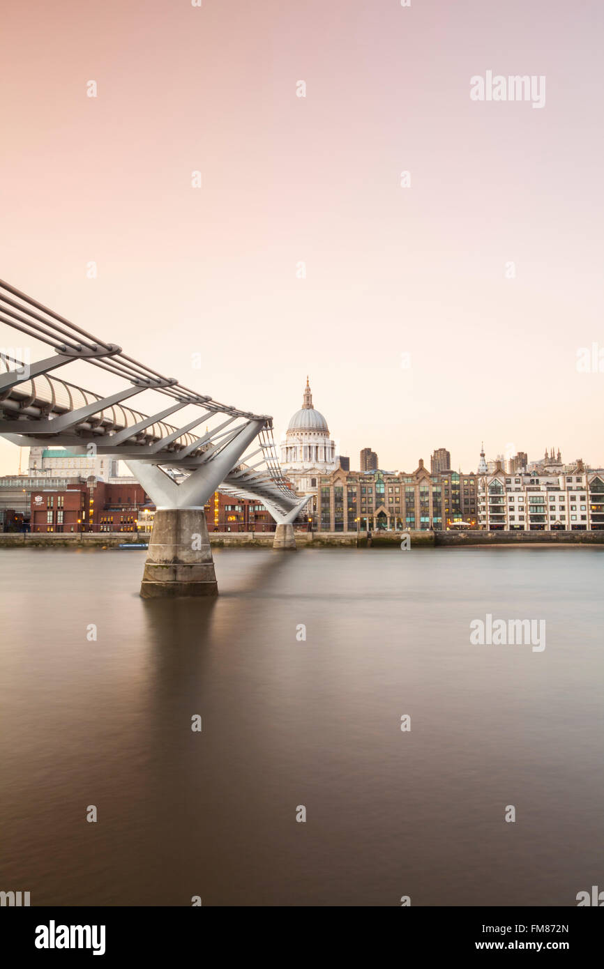 View of St. Paul's Cathedral, London, across the Millennium Bridge and River Thames at sunset Stock Photo