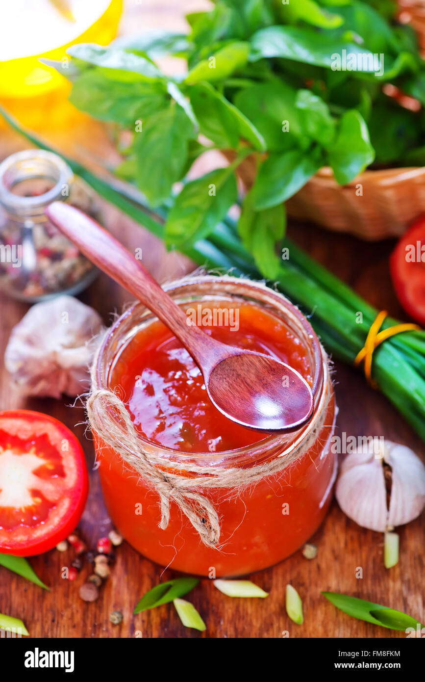 tomato sauce in glass bank and on a table Stock Photo - Alamy
