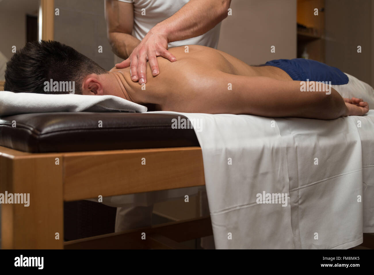 Masseur Doing Massage On Man Body In The Spa Salon Stock Photo