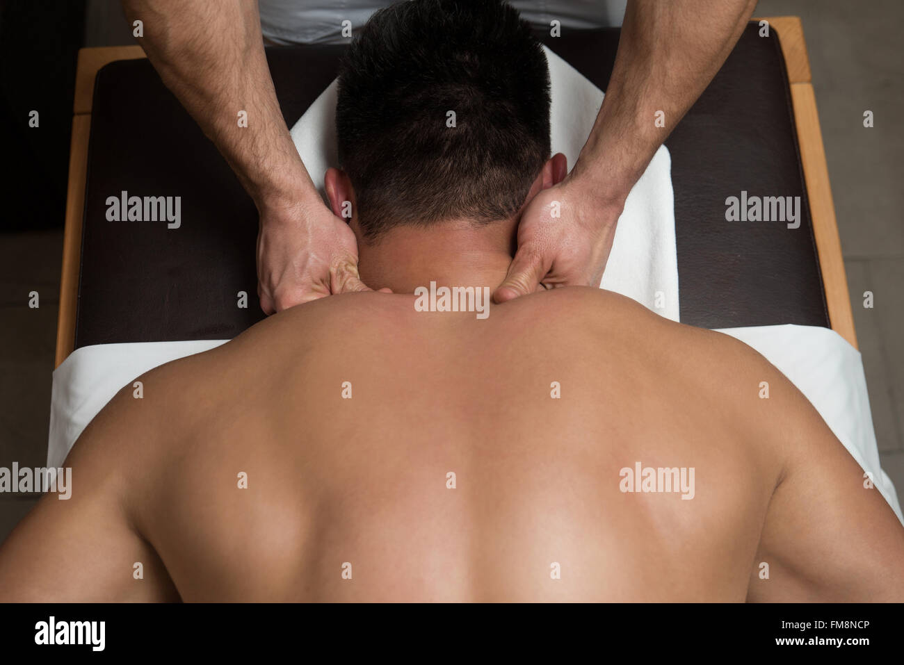 Masseur Doing Massage On Man Body In The Spa Salon Stock Photo