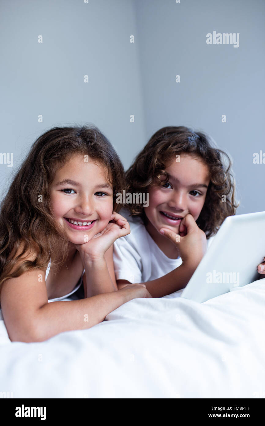 Portrait of brother and sister using digital tablet Stock Photo - Alamy