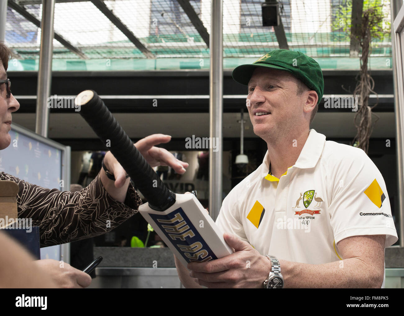 Australian cricket team member hands signed bat to supporter in Brisbane, australia Stock Photo