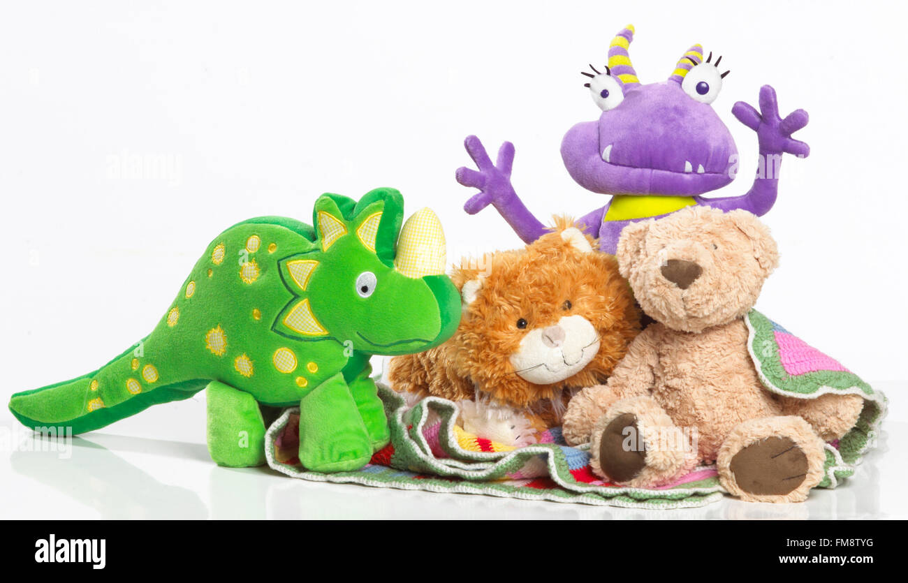 Soft toy dinosaur, marmalade cat, alien and teddy bear Stock Photo Alamy