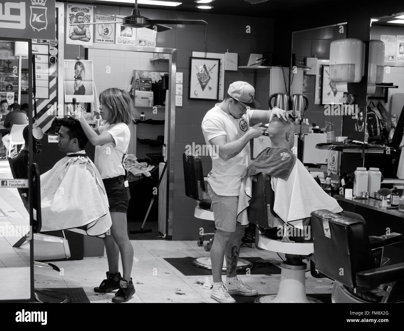 male and female hairdressers barbers groom customers in hairdressing salon at surfers paradise gold coast, queensland Stock Photo
