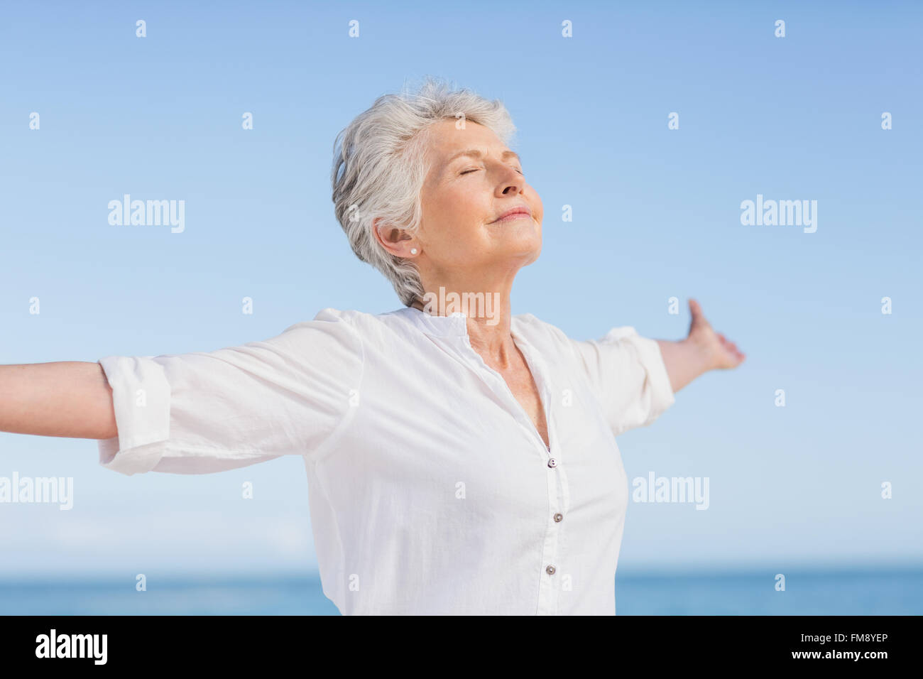 Senior woman relaxing on the beach Stock Photo - Alamy