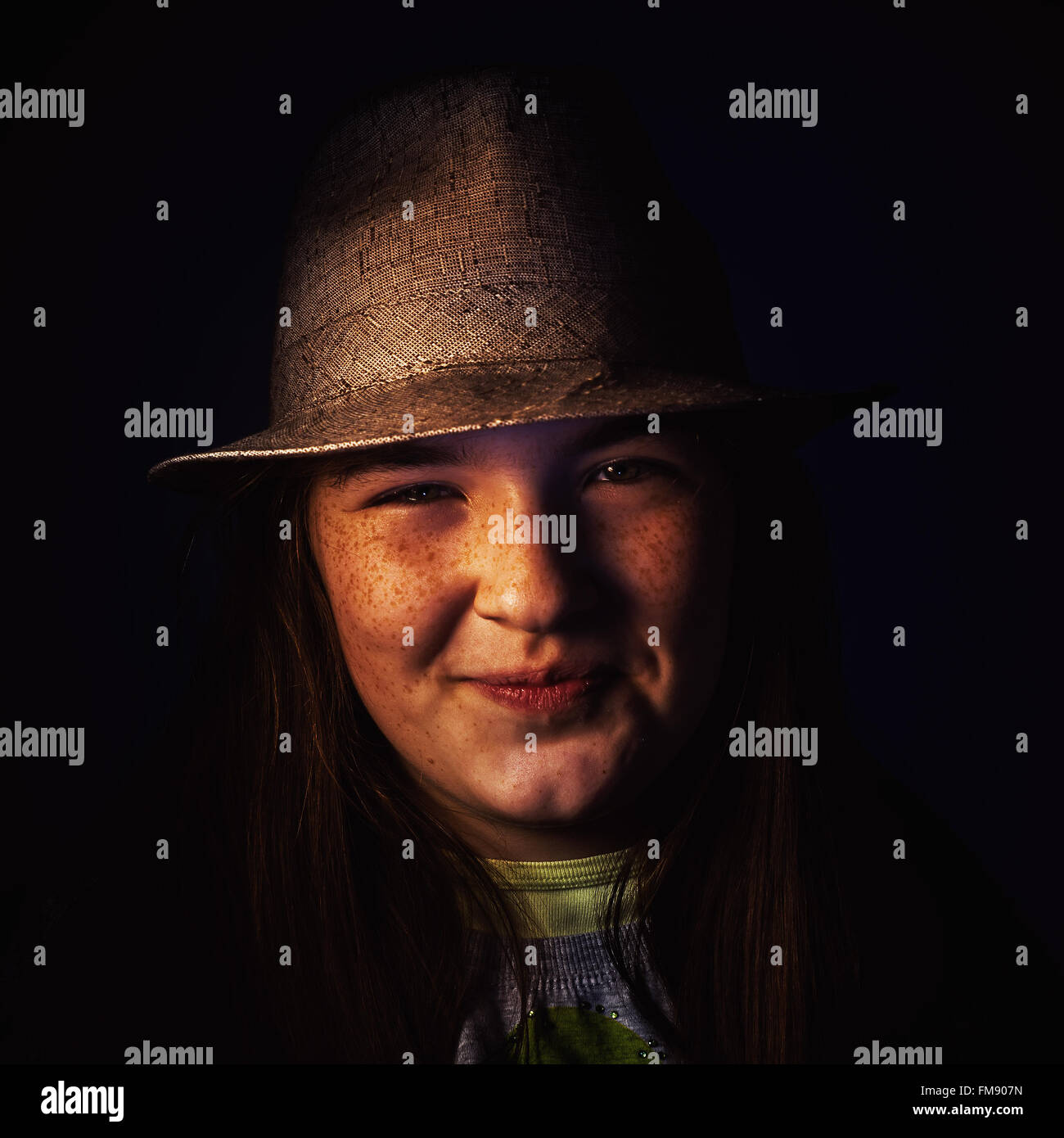 Studio portrait of a young girl wearing a hat and smiling Stock Photo ...