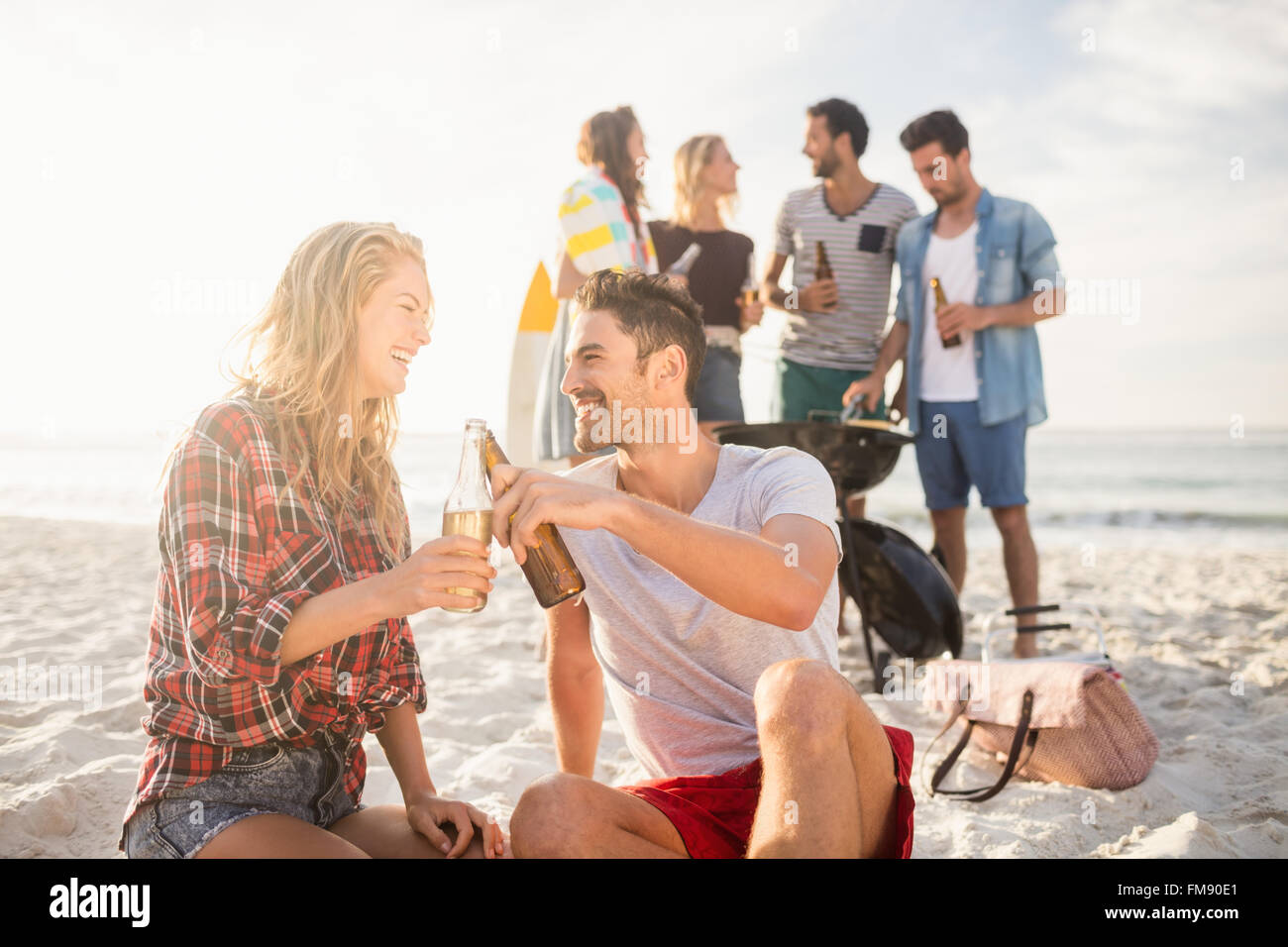 Happy friends having fun around barbecue Stock Photo - Alamy
