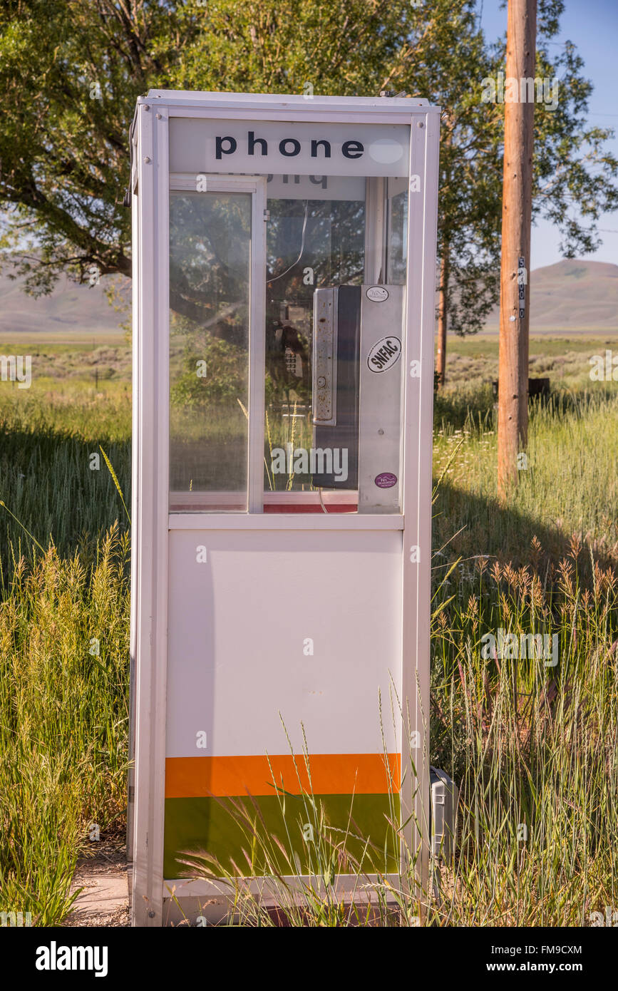 Old Phone Booth Box in outdoors and old pay phone in booth box. USA Stock Photo