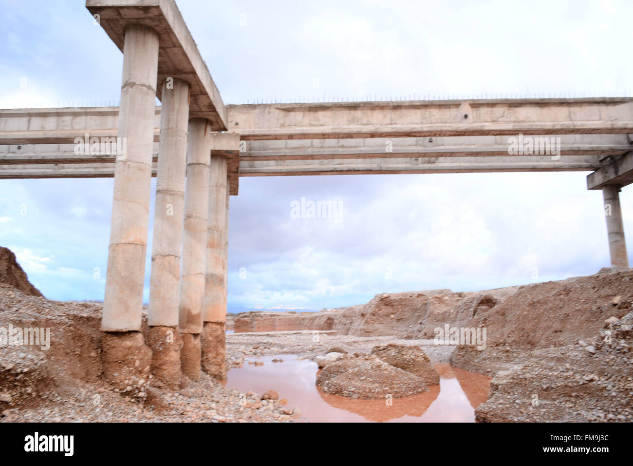 Quetta, Pakistan. 11th March, 2016. The foundations of the under construction bridge has been washed away in raining for last three days. The National Disaster Management authority 'PDMA' has predicted more rains and flood and has warned the people in the next three day in Quetta Pakistan. Credit:  Din Muhammad Watanpaal/Alamy Live News Stock Photo