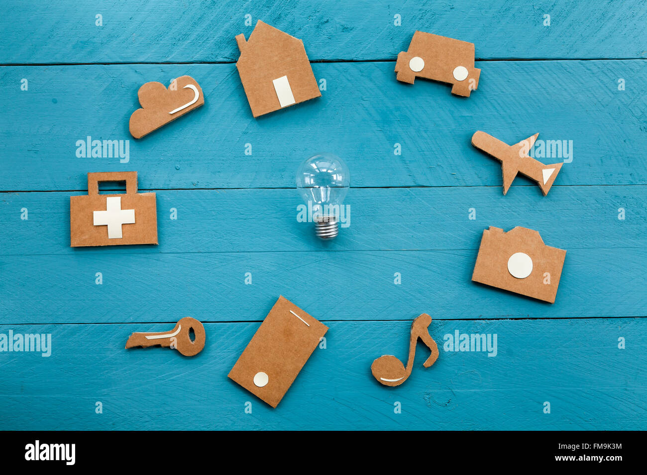 Cardboard web icons  and light bulb on blue background Stock Photo