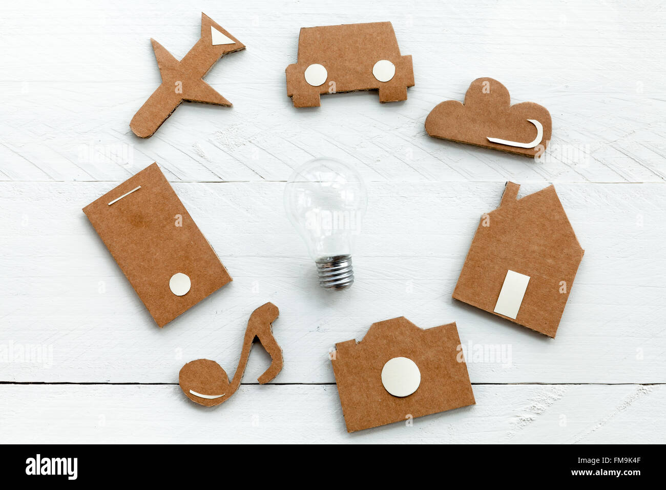 Cardboard web icons  and light bulb on blue background Stock Photo
